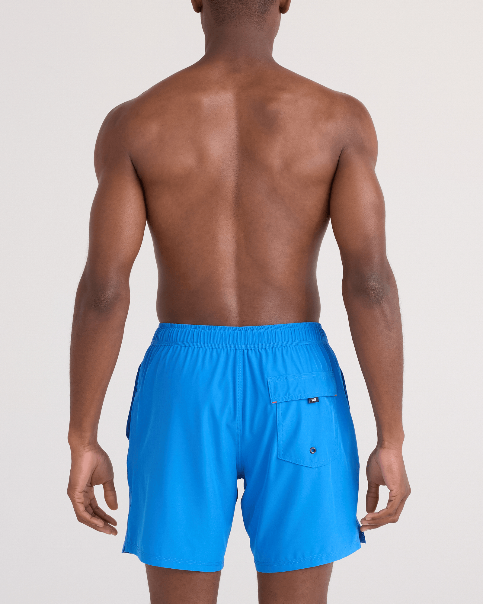 Back - Model wearing Oh Buoy 2N1 Swim Trunk 7" in Bold Blue