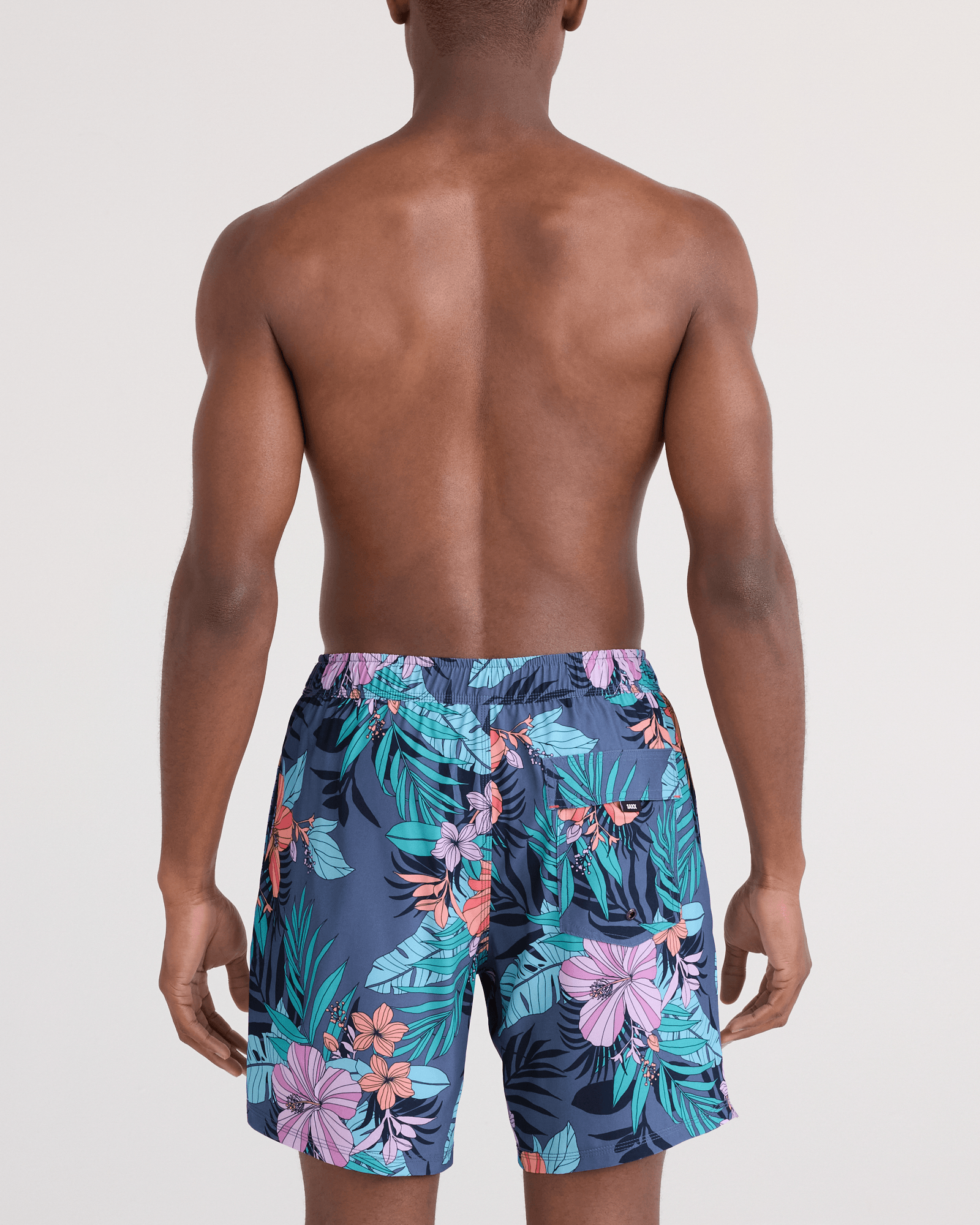 Back - Model wearing Oh Buoy 2N1 Swim Trunk 7" in Hibiscus Jungle-Indigo