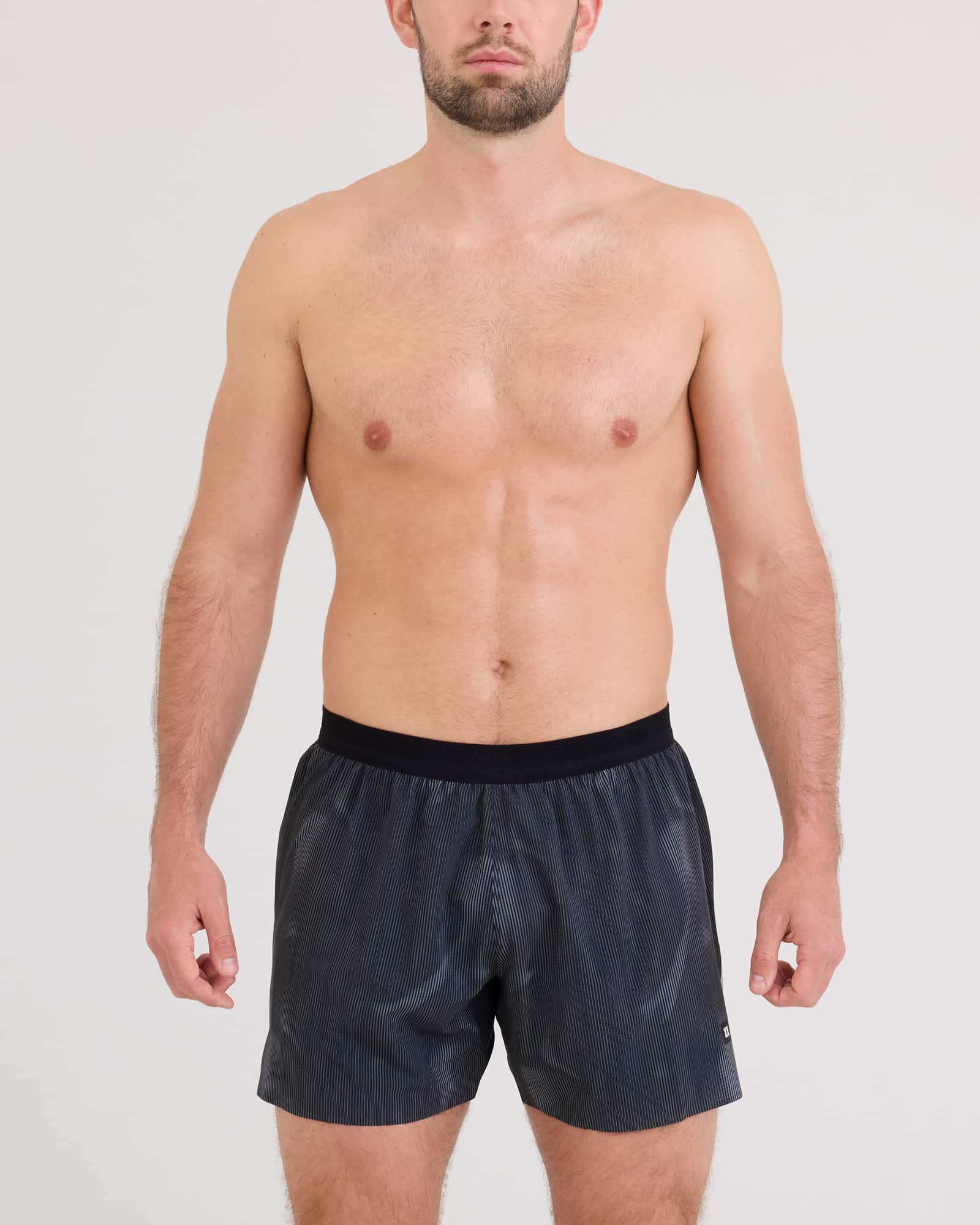 Front - Model wearing Race Pace 2N1 Run Short 5" in Smoke Camo-Dark Charcoal