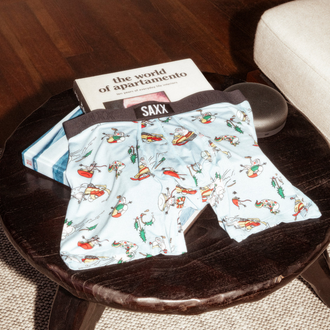 Baby blue Boxer Briefs in wintry print draped over a stack of books